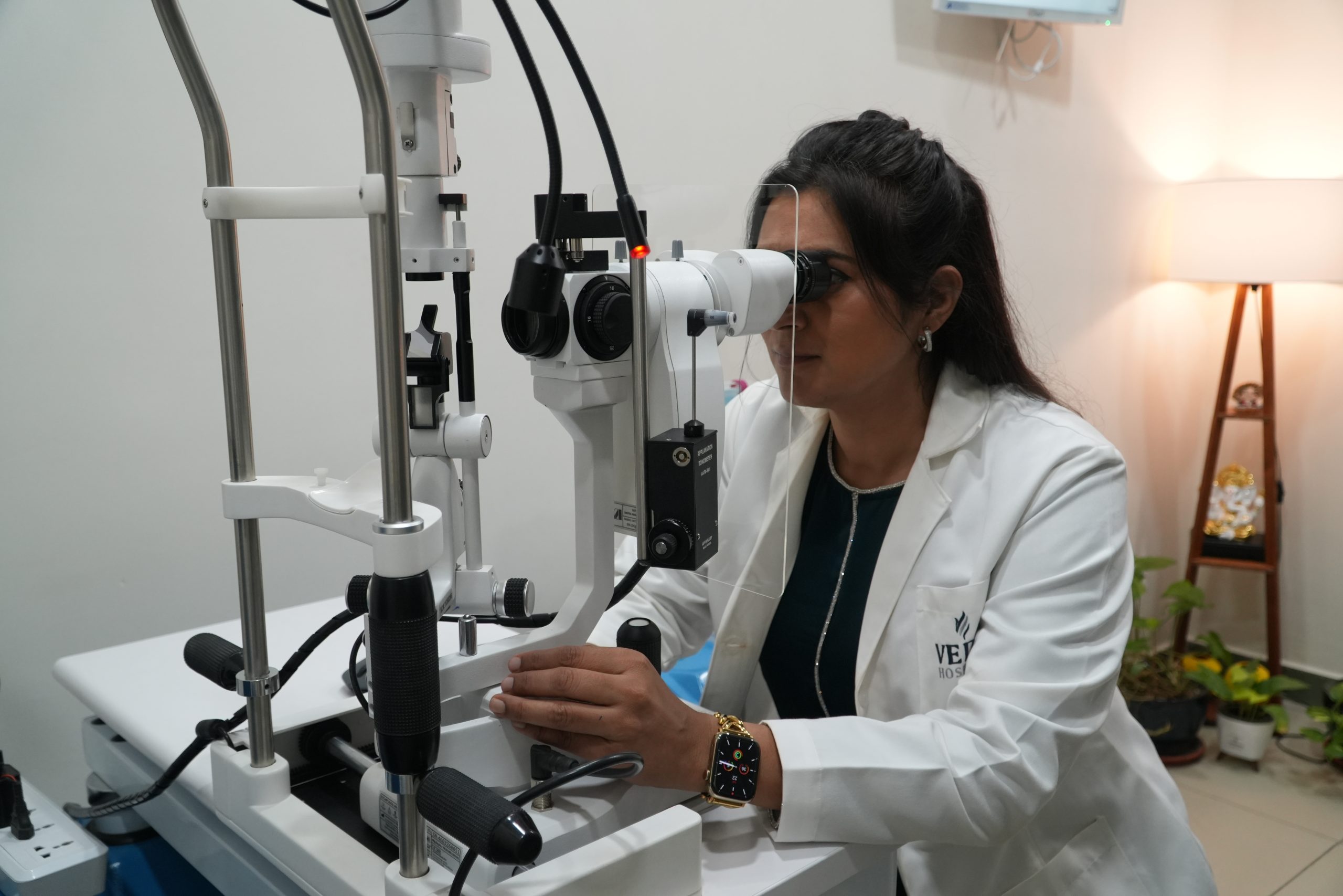 Dr. Ripan Kaur performing an eye examination using an ophthalmic machine